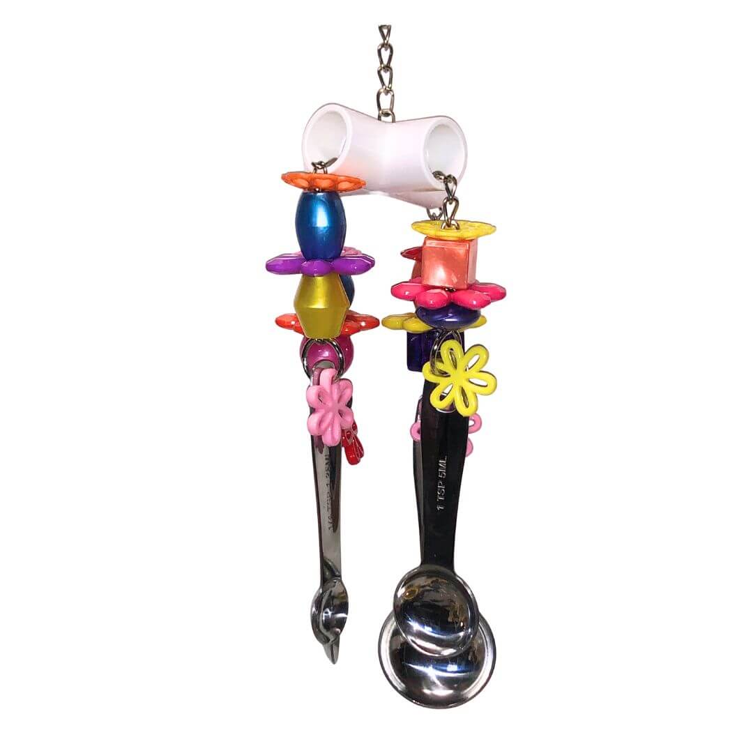 Colorful bird toy with beads and a white cup on a white background