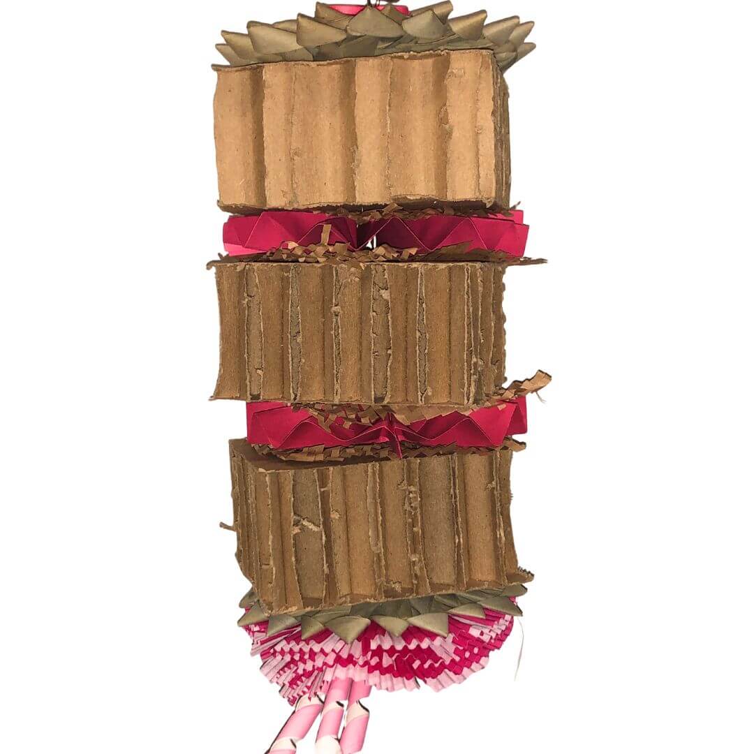 large cardboard bird toy with pinwheels and shreddable bird items.