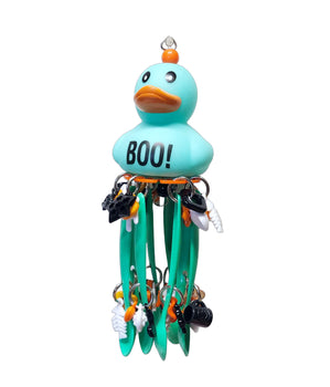 rubber duck with spoons and lots of charms hanging from it. Great halloween bird toy 