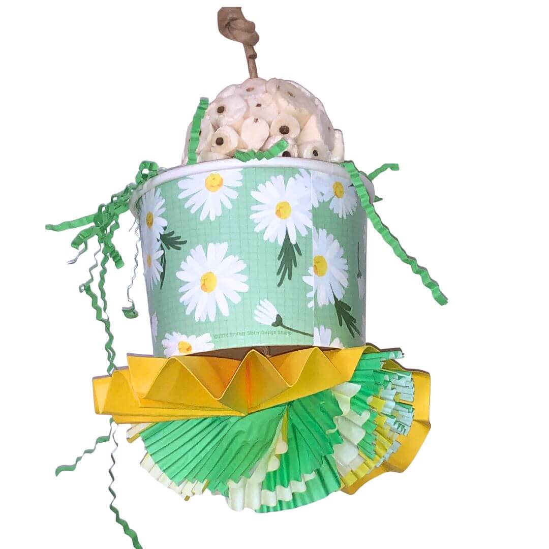 Bird Toy with Sola ball inside a floral-patterned paper cup  on a white background