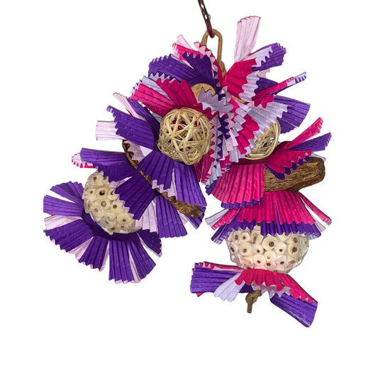 bird toy in pine and purple with lots of different shredder. 