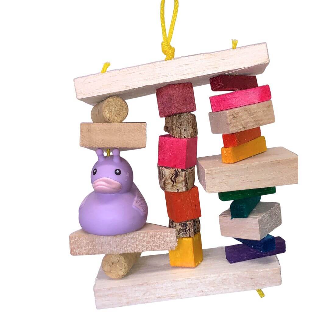 balsa bird toy with a purple duck figure on a white background