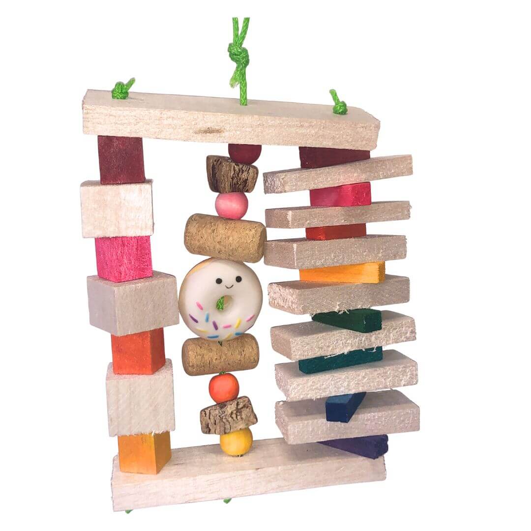 Colorful balsa bird toy with various shapes and a donut-shaped toy on a white background