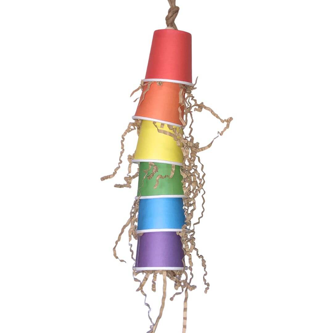 Colorful bird toy made of stacked paper cups on a white background