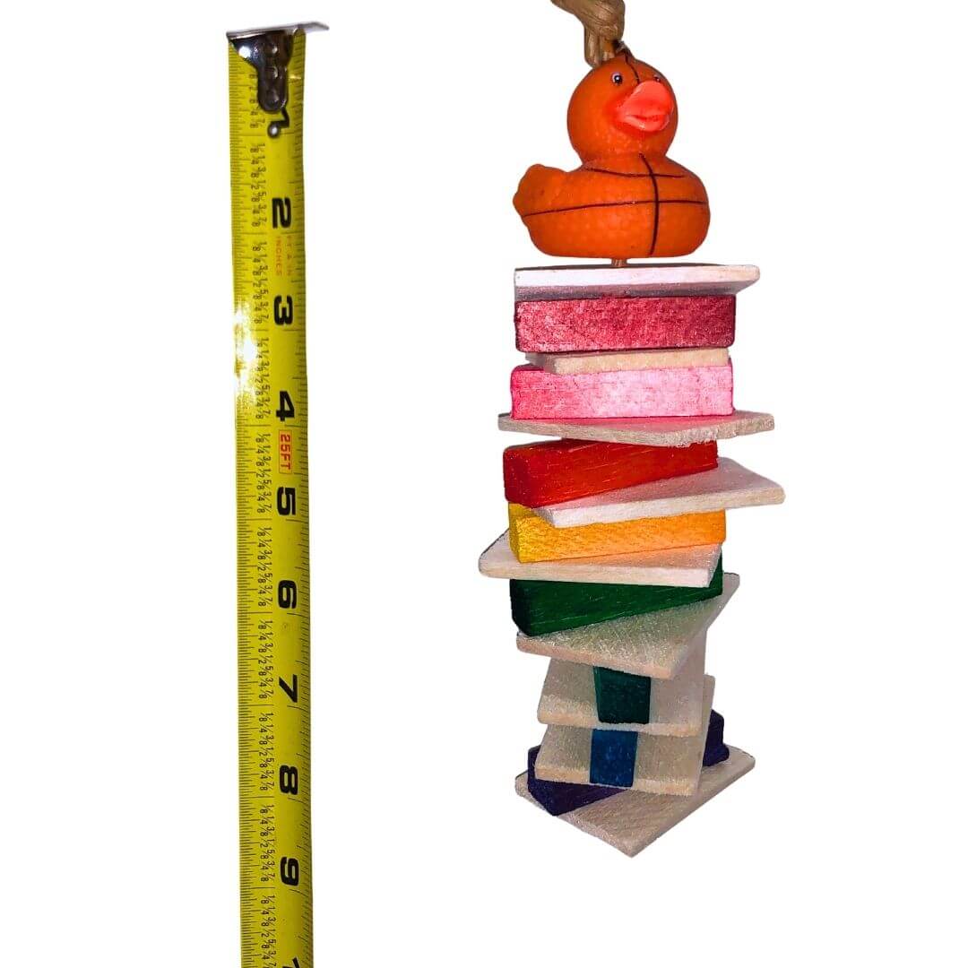 A colorful hanging bird toy made of soft balsa wood with a duck figure on top.