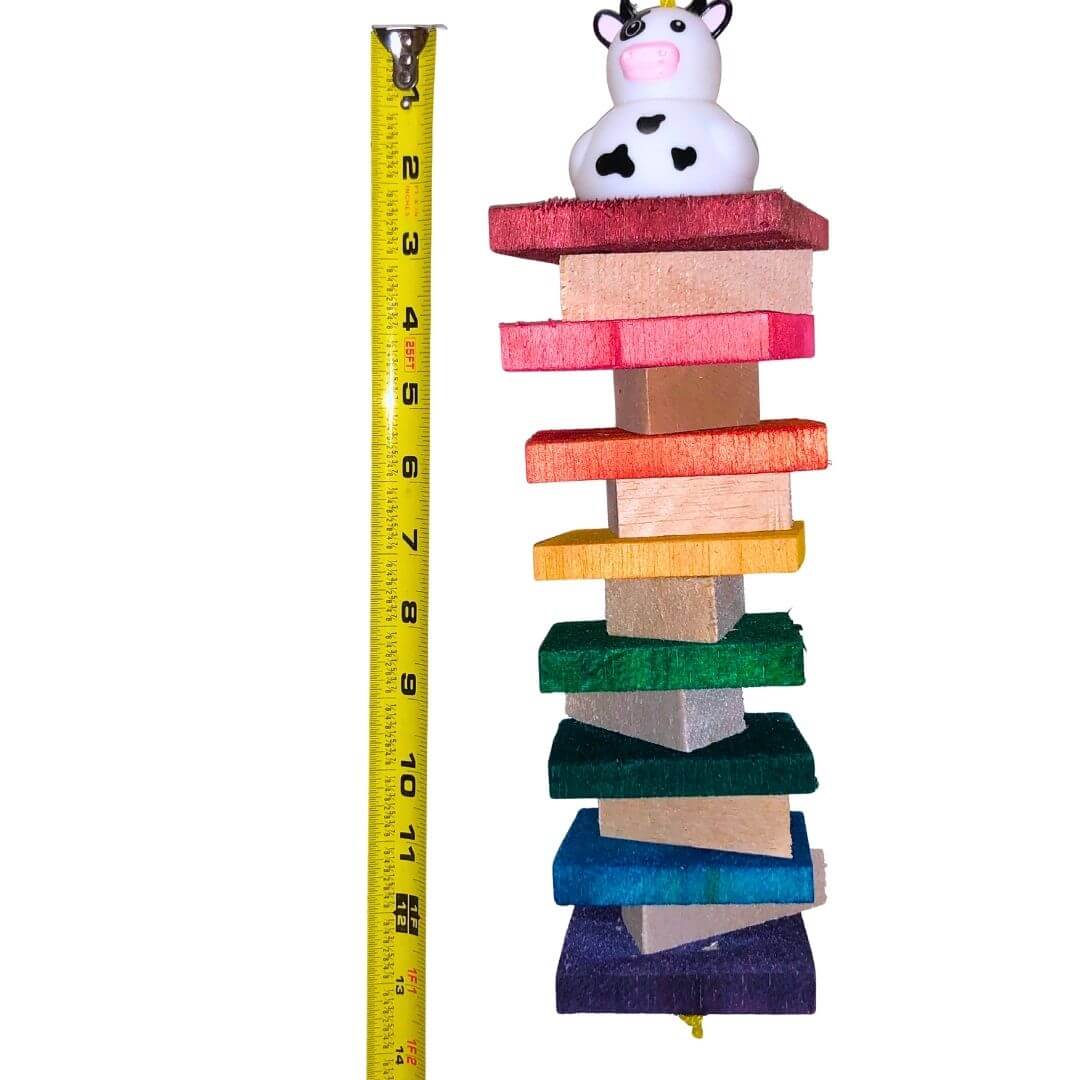 A colorful hanging bird toy made of soft balsa wood with a duck figure on top.