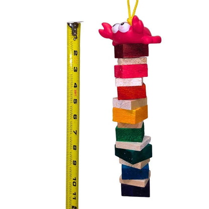 A colorful hanging bird toy made of soft balsa wood with a duck figure on top.