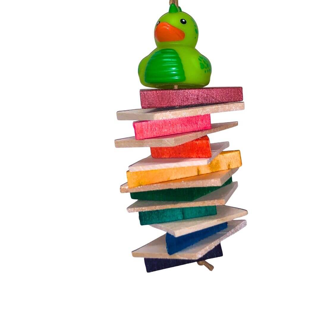 A colorful hanging bird toy made of soft balsa wood with a duck figure on top.