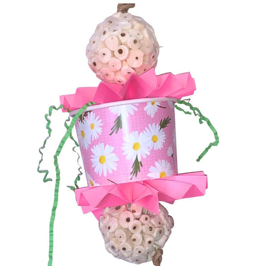 Foraging bird toy with  pink floral-patterned bucket, pink bow, and decorative elements on a white background