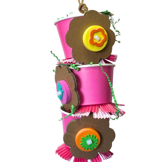 Bird toy with decorative pink cups with brown flower designs on a white background