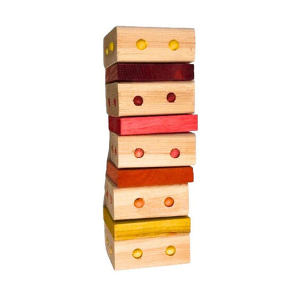 A colorful wooden bird toy with multiple blocks in red, yellow, and orange, arranged in a stack with holes drilled into each block.