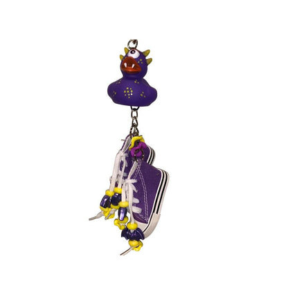 Purple shoe charm bird toy with charms  on a white background
