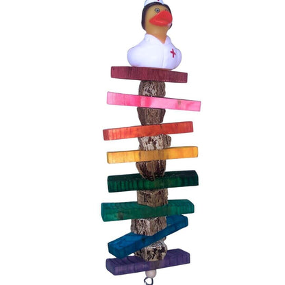 A vertical wooden bird toy or chew with a natural pods and stacked rainbow-colored wooden bars, topped with a small rubber duck 