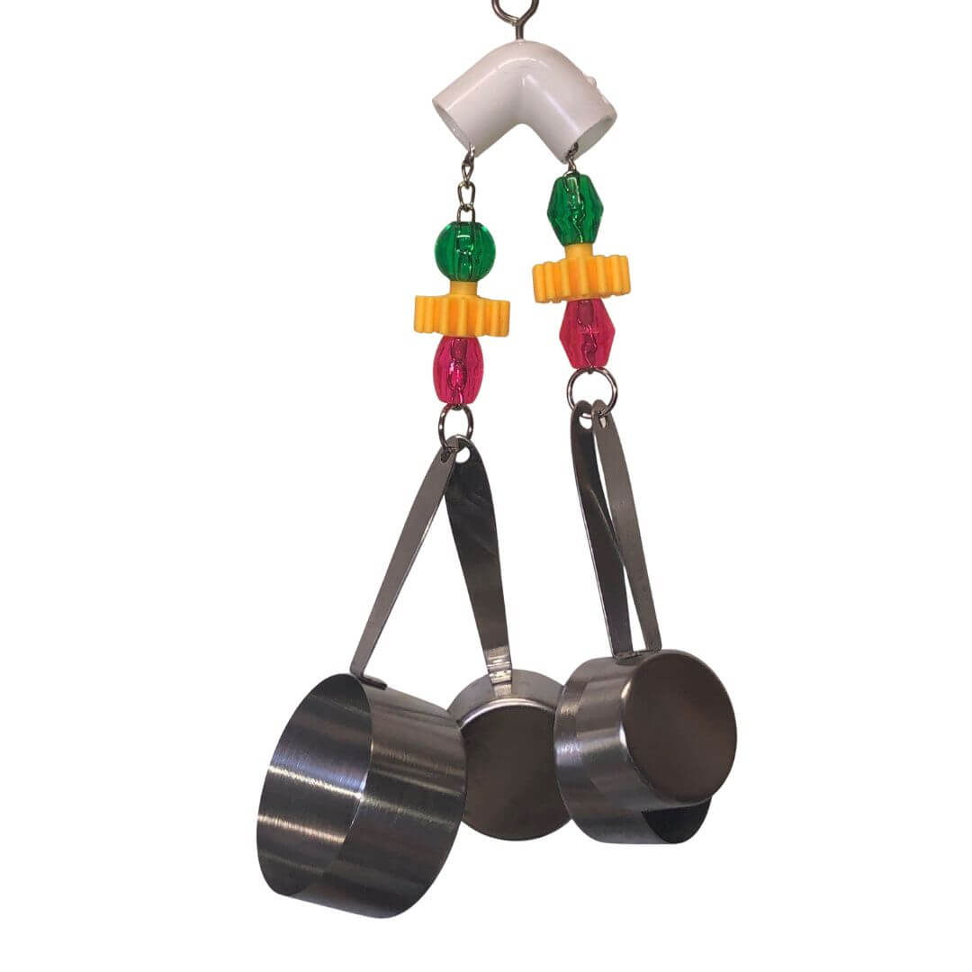 Metallic measuring cups with colorful beads on a white background