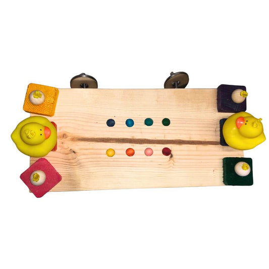 A wooden toy board with colorful blocks and duck-shaped pieces, photographed on a plain white background.