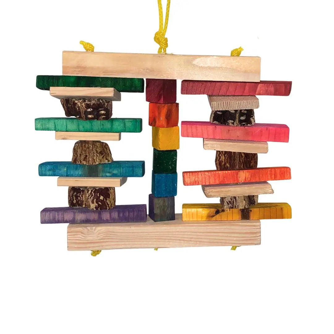 A wooden hanging bird toy with multiple colorful stacked blocks and pod pieces, suspended by a yellow poly rope on a white background.