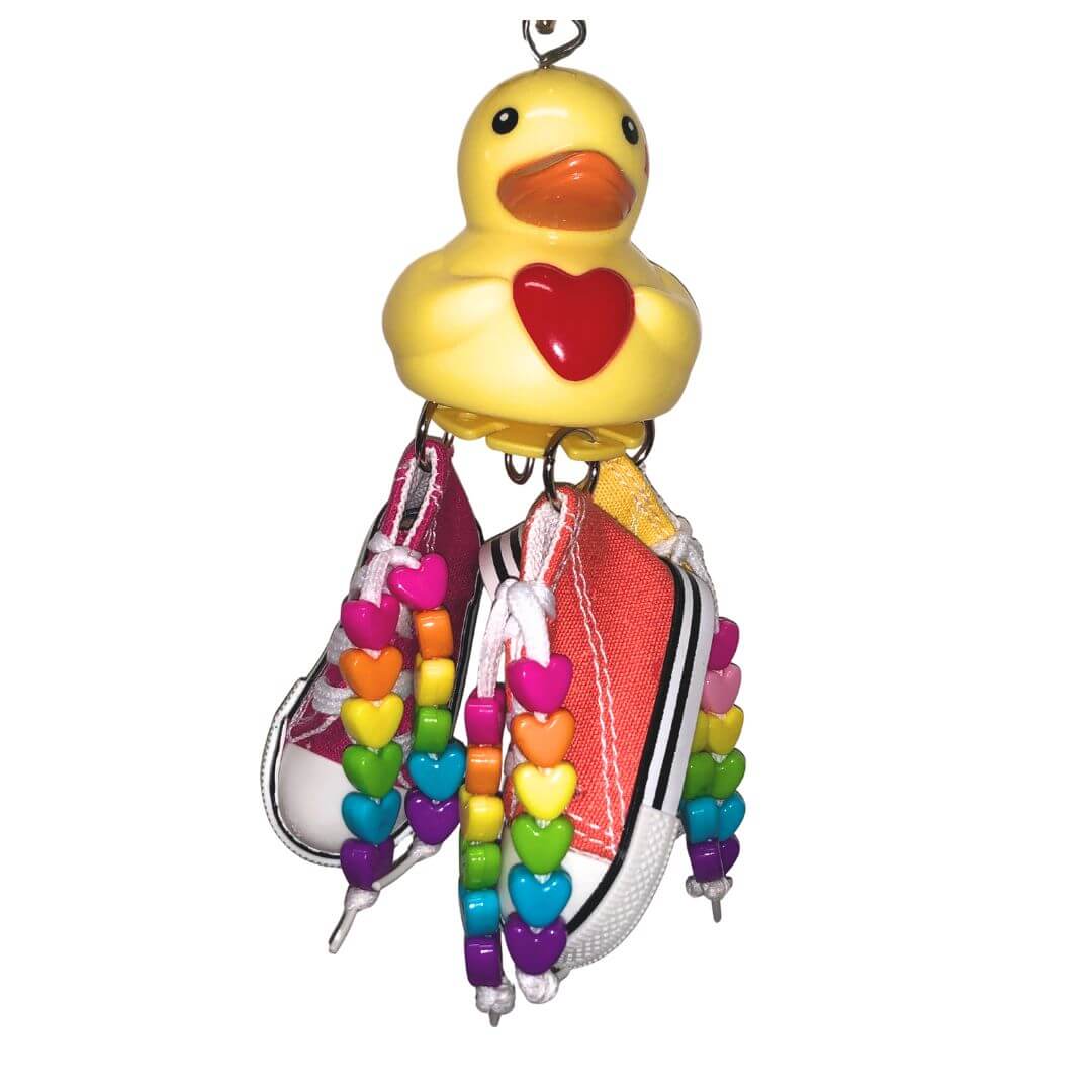 Duck bird toy with three shoes. Rainbow heart shaped beads on shoe string. 