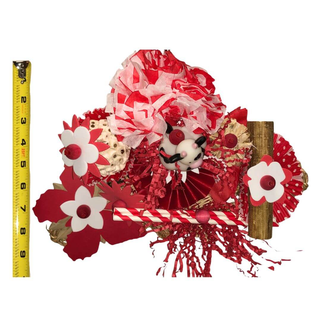Bird Toy with red and white flowers and a measuring tape for scale on a white background
