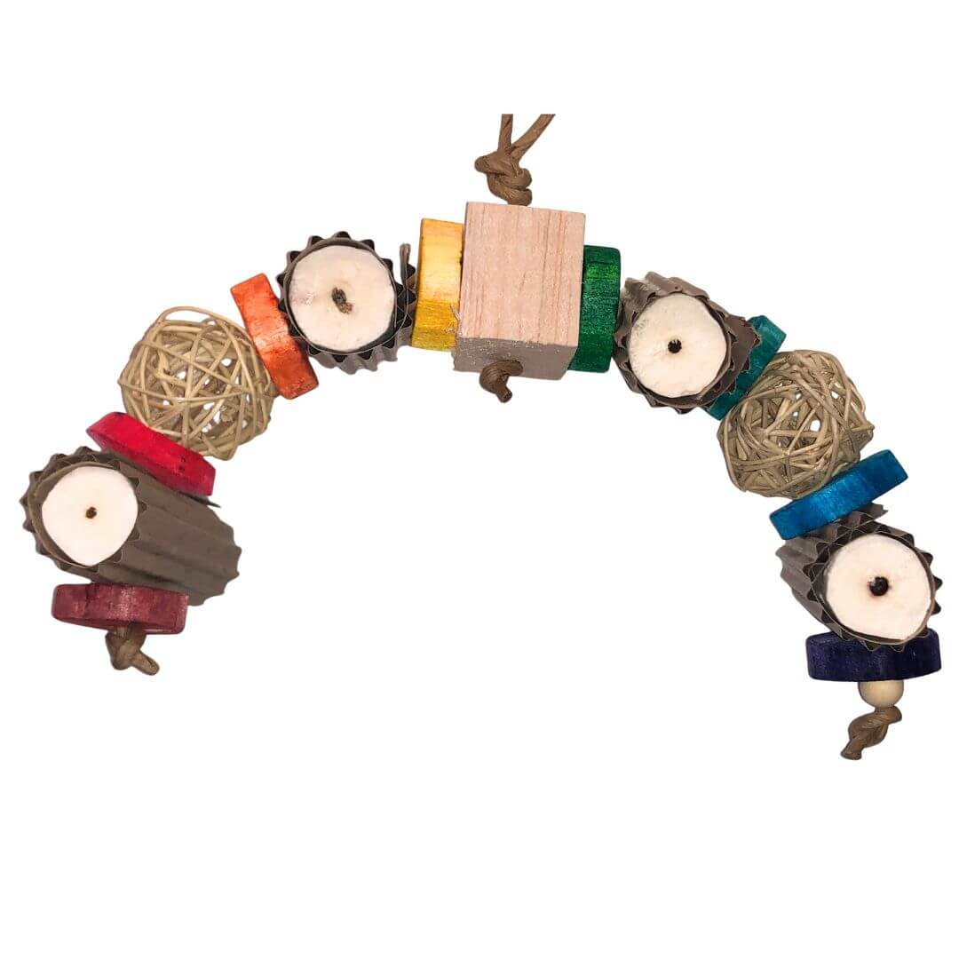 Colorful bird toy with wooden blocks and spherical elements on a white background