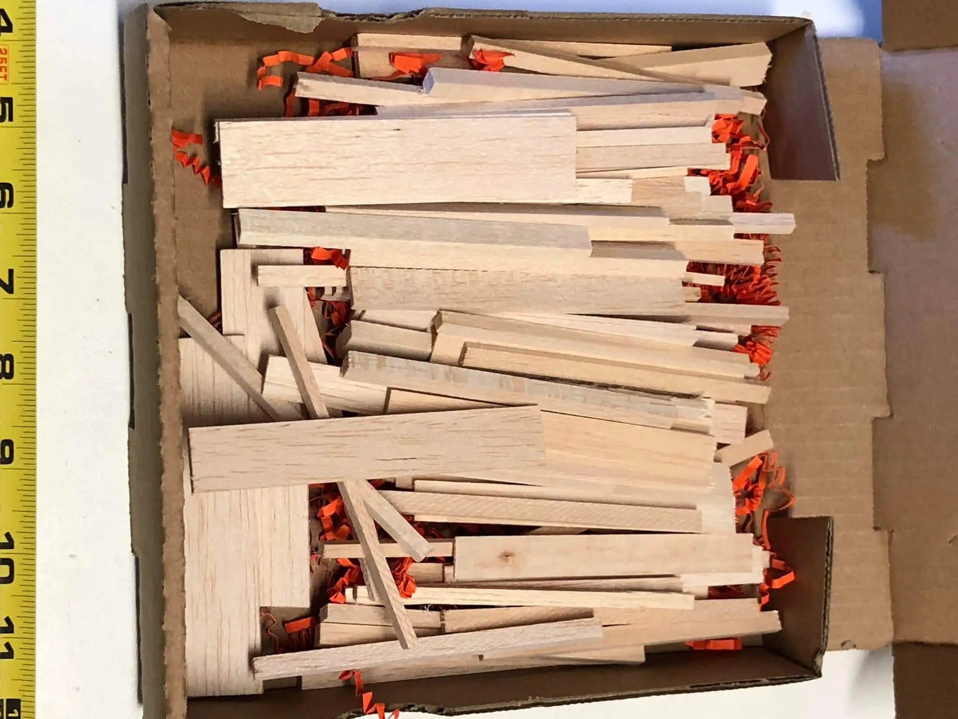 Natural balsa sticks in pizza box