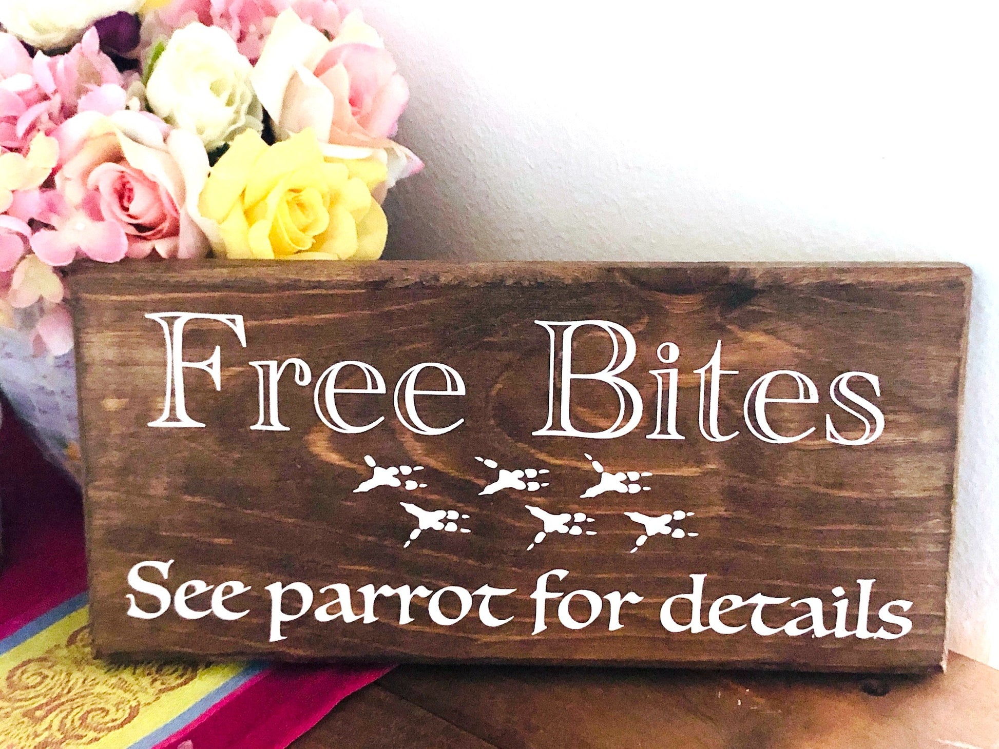 brown stain wood sign "free bites, see parrot for details"